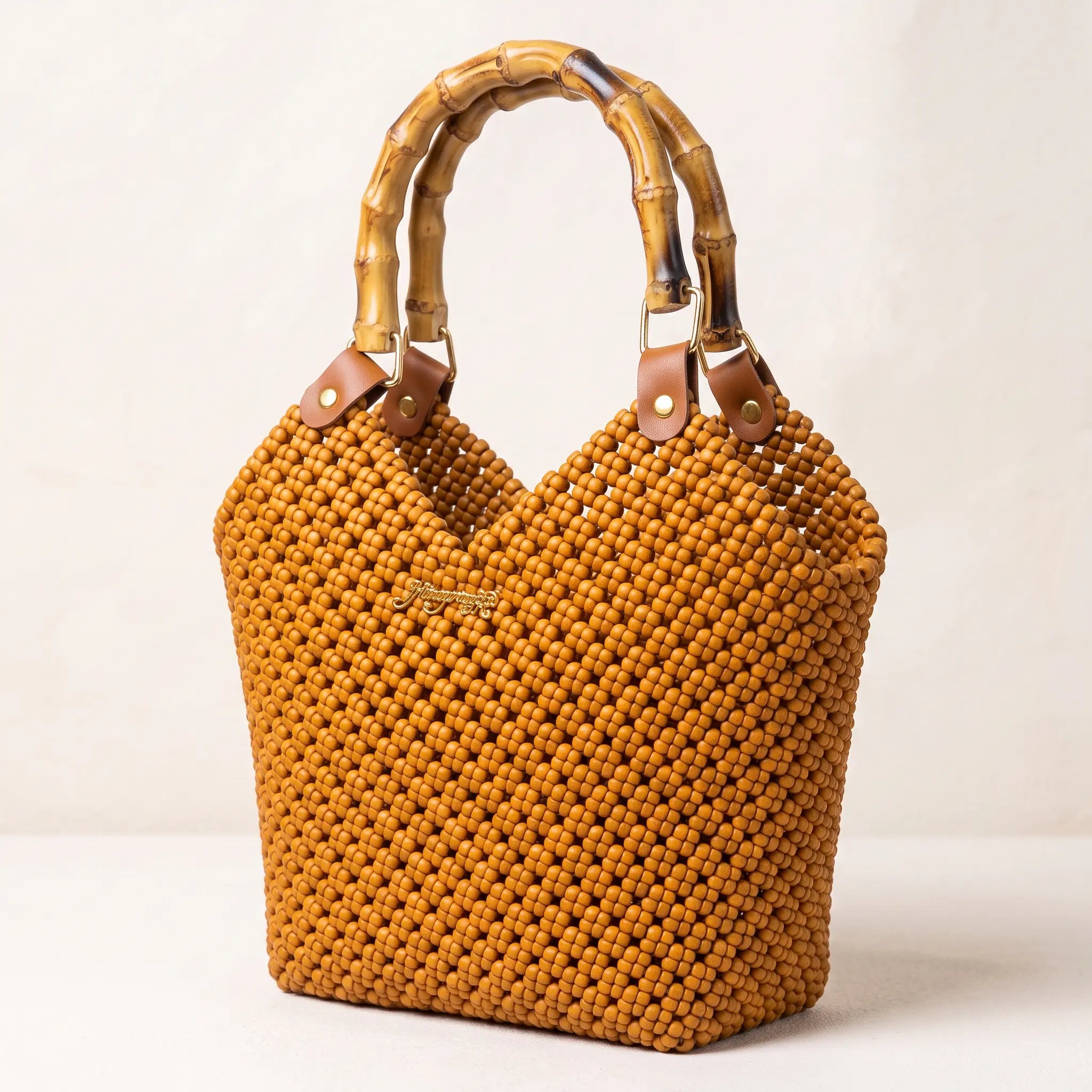 Close-up of the handwoven PE rattan texture on a caramel brown tote bag.