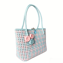 Floral detail on a handmade pastel PE rattan woven tote bag.